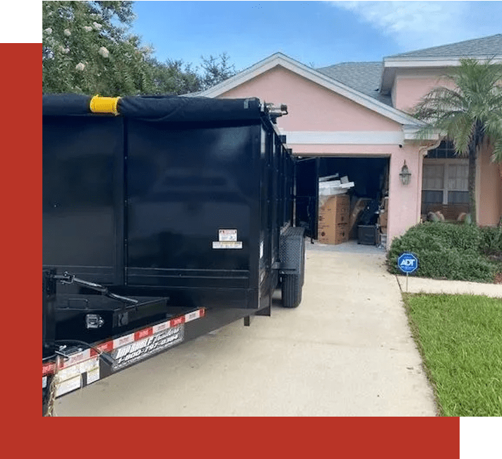 A black truck parked in front of a pink house.