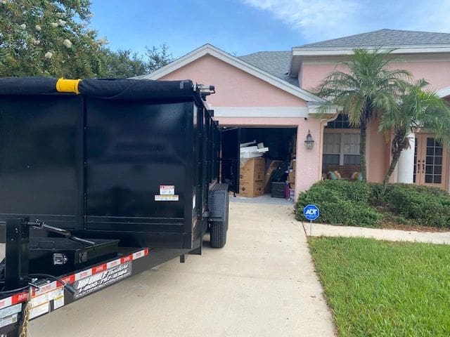 A black truck parked in front of a house.